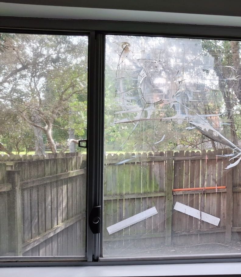 Broken glass in an aluminium sliding window before replacement