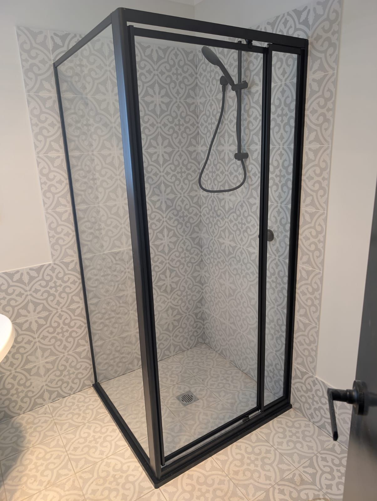 Framed shower screen with matte black aluminium frame
