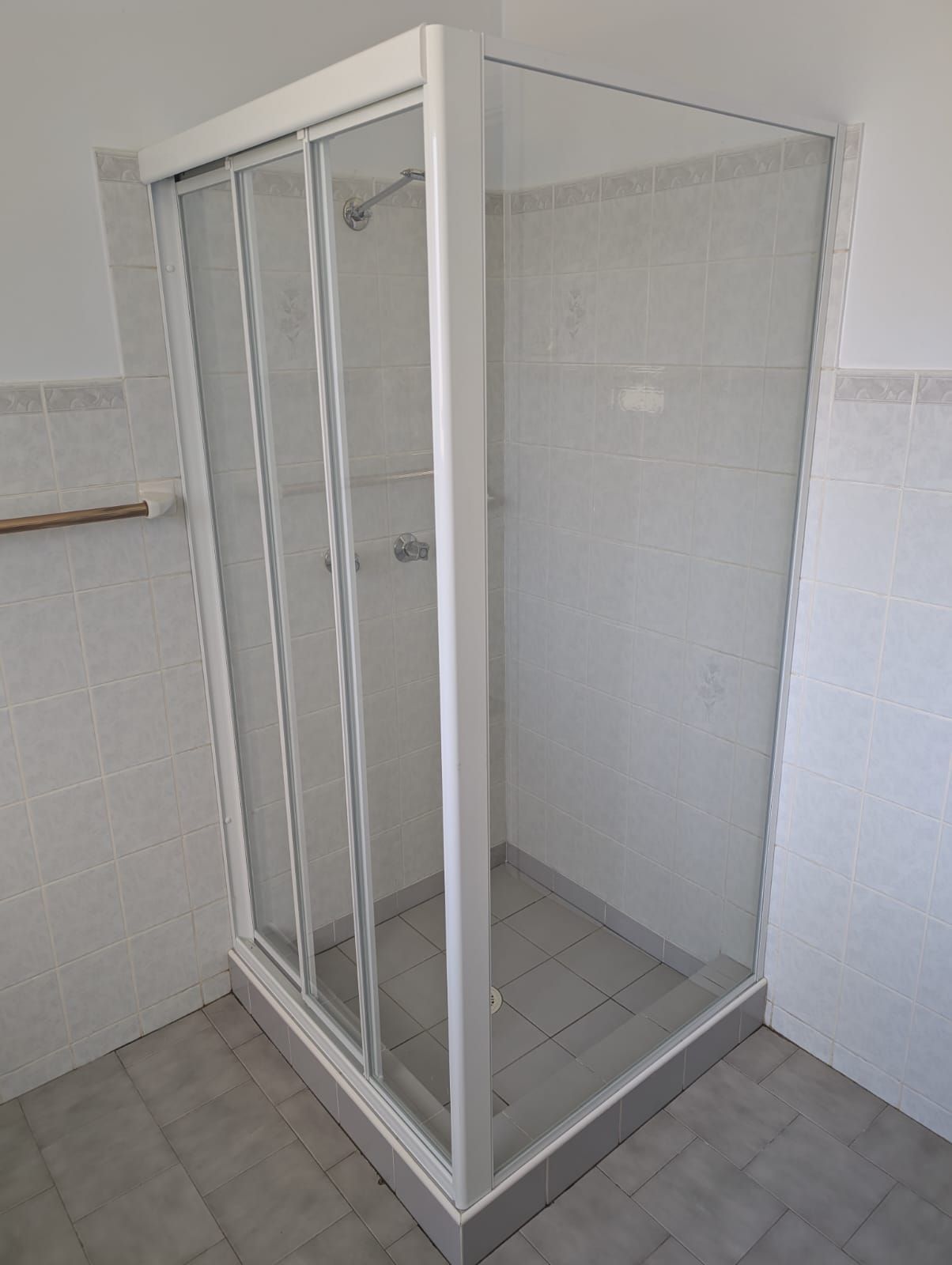 Framed sliding shower screen with white aluminium frame