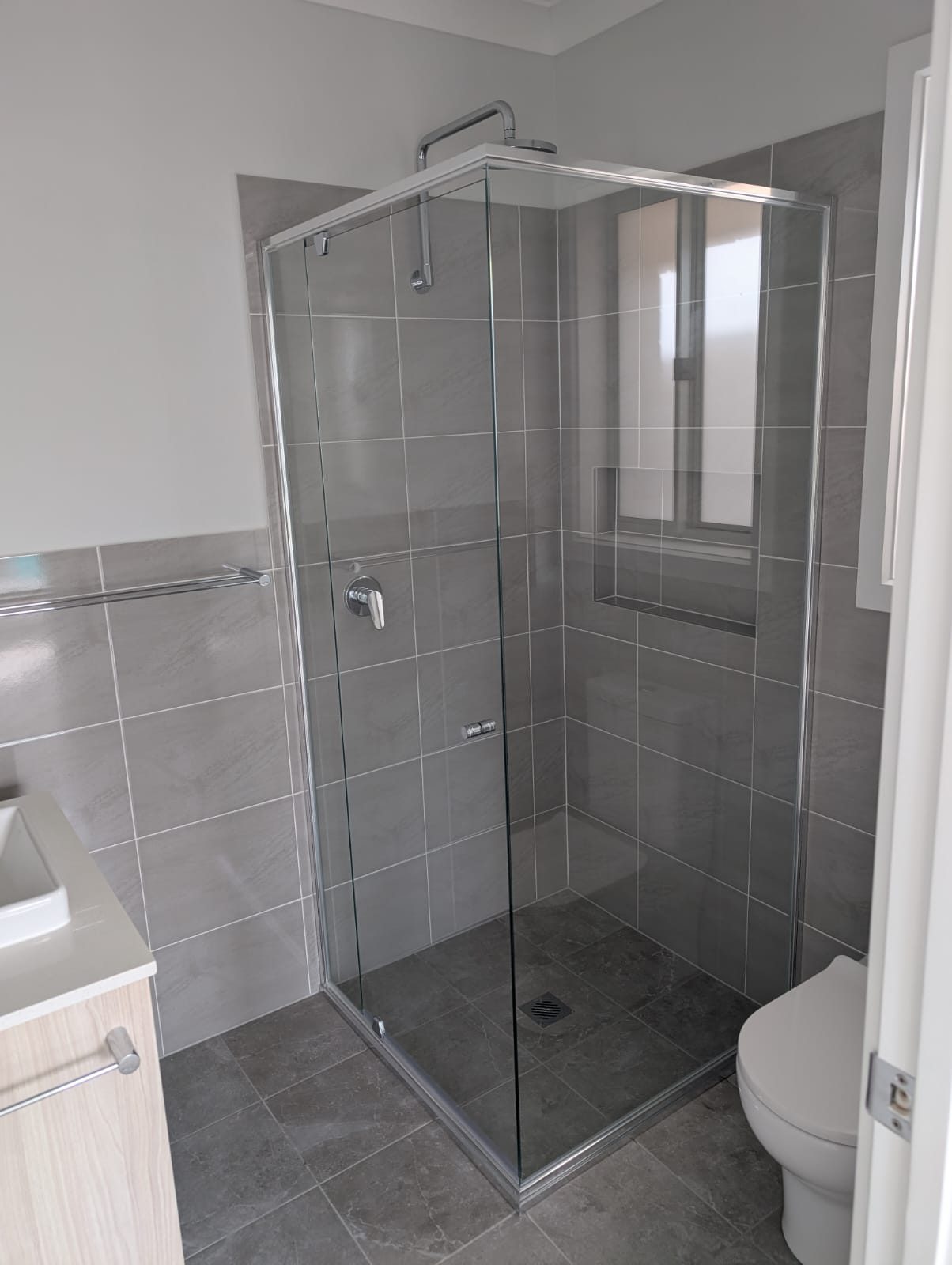 Semi-frameless corner shower screen with chrome fittings
